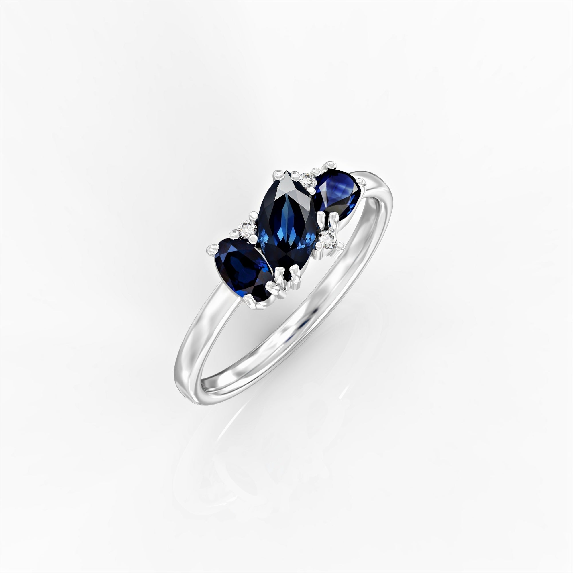 Kan ring - a cluster ring set with a marquise sapphire, an oval, a drop and diamonds