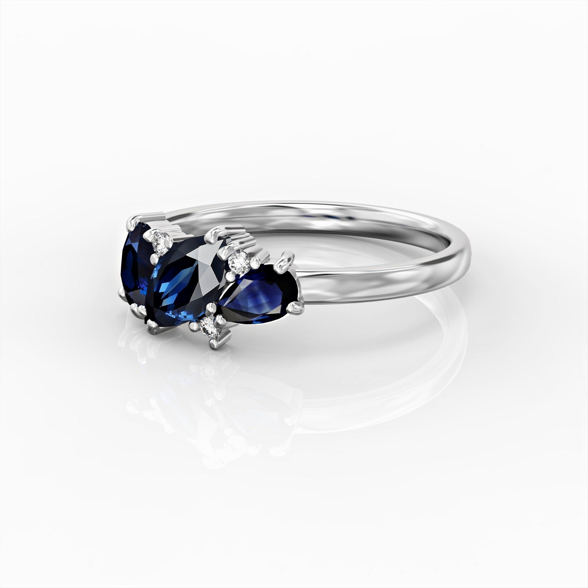 Kan ring - a cluster ring set with a marquise sapphire, an oval, a drop and diamonds